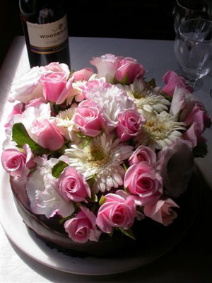 Cake flowers, lush and full with roses, gerberas and lisianthus.