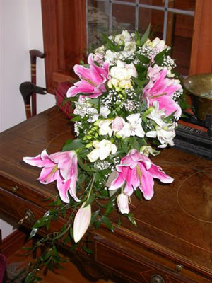 Traditional Cascade Wedding Bouquet of sorbonne lilies, roses, alstromaeria, freesia