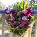 European Handtied Bouquet of tropical foliages, lisianthus, amaranthus, sedum, germinis, celosia cristata