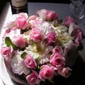 Cake flowers, lush and full with roses, gerberas and lisianthus.
